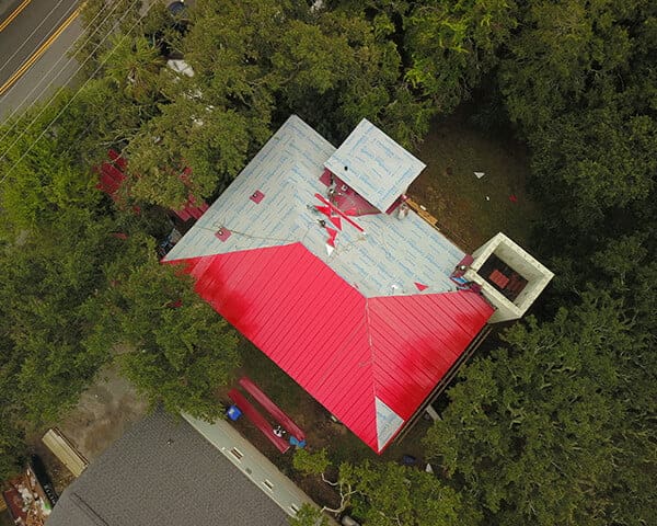 Aerial view of metal roof installation in progress