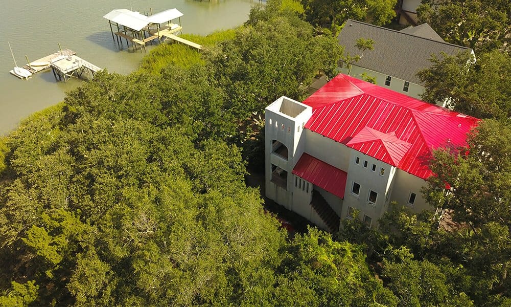 Aerial view of a new red metal roof on a two-story home