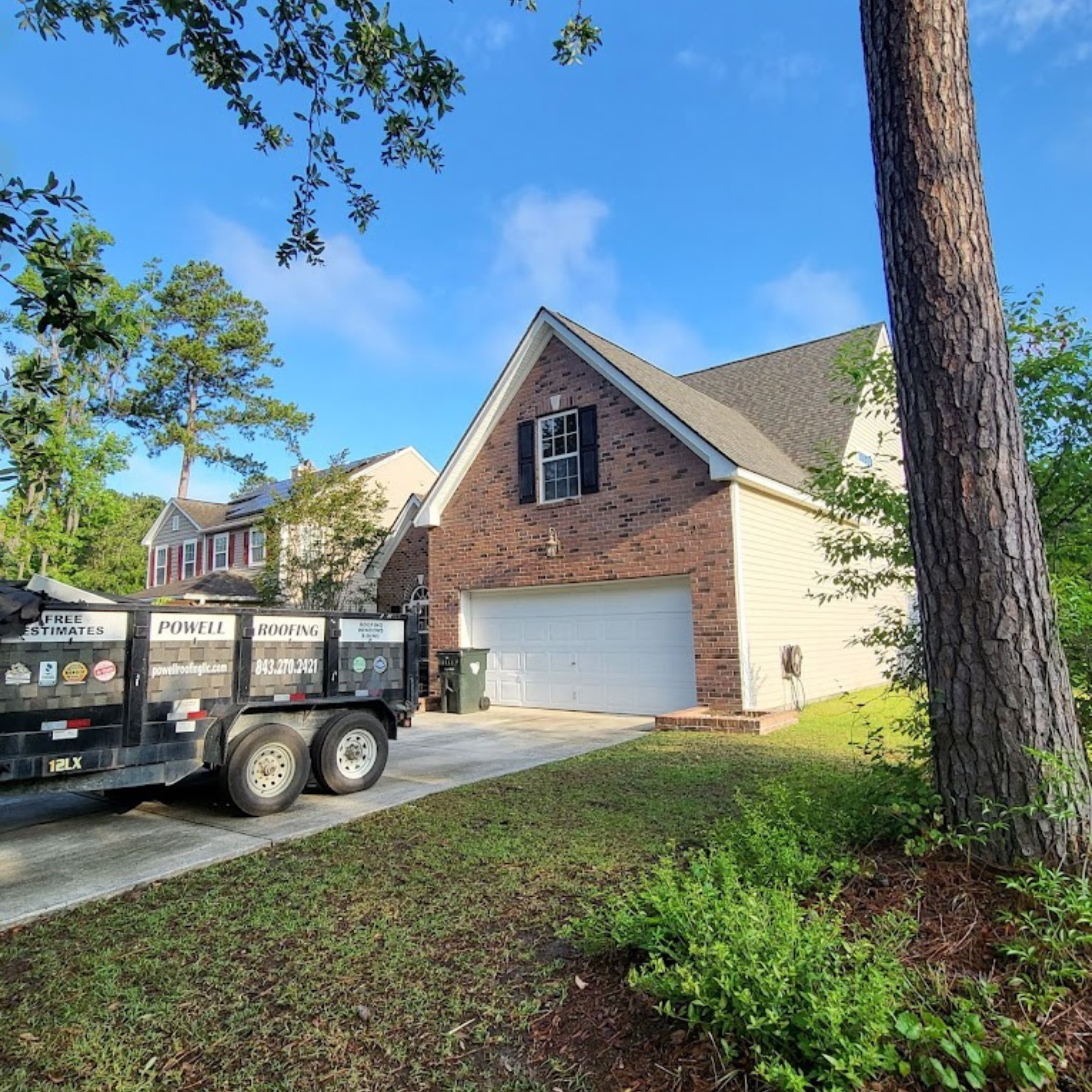 Two-story home with a work truck in the driveway